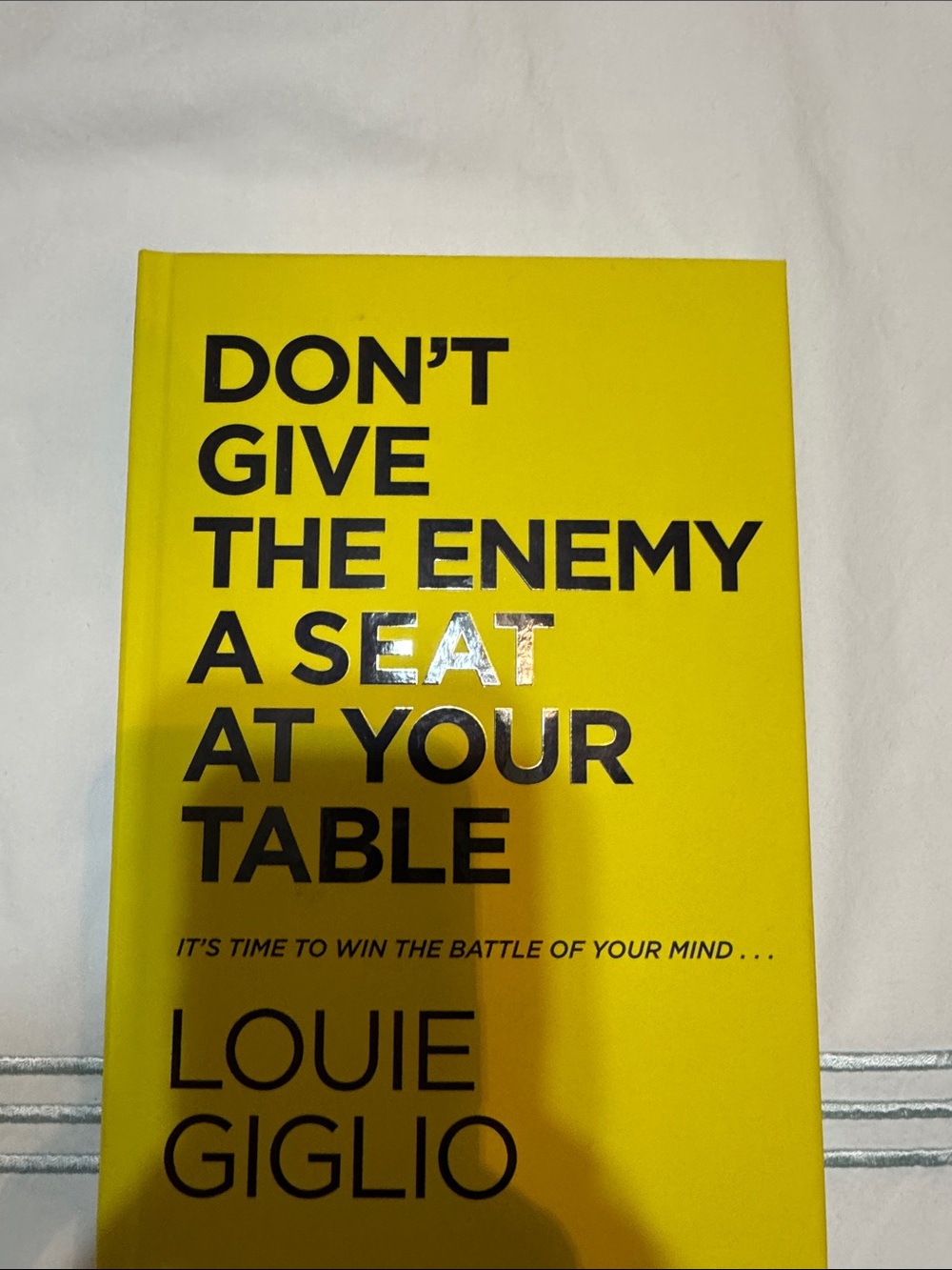 Don't Give the Enemy a Seat at Your Table by Louie Giglio - Yellow Hardcover